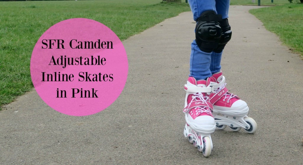 Person wearing pink and white SFR Camden adjustable inline skates with knee pads is skating on a park path, learning new skills. Text on image reads: “SFR Camden Adjustable Inline Skates in Pink.”.