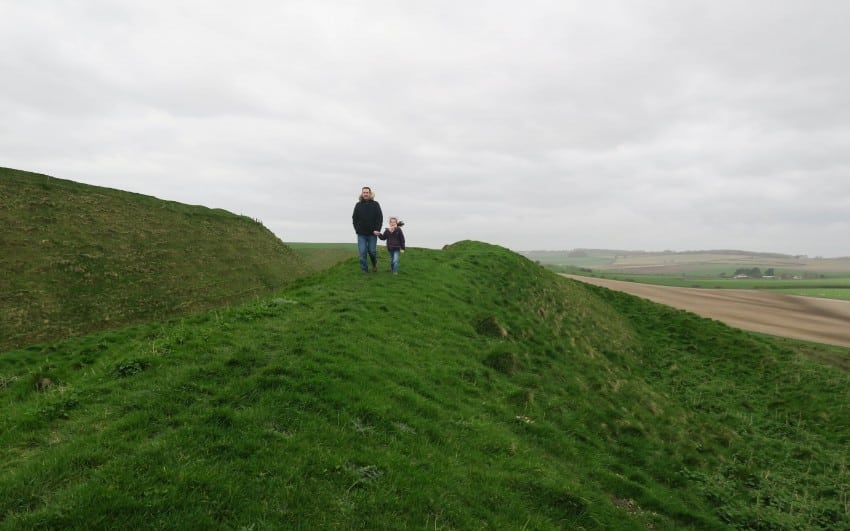 Two people walk along a narrow, grassy ridge under a cloudy sky, with rolling hills and open fields stretching out in the background—a perfect moment from Week 15 for our weekend in pictures.