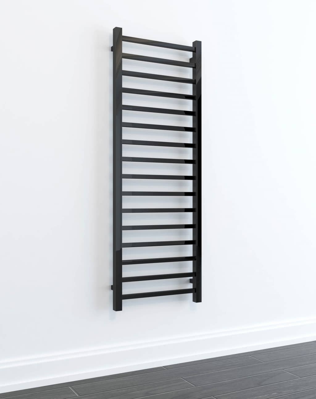 A black, wall-mounted towel radiator with horizontal bars is installed on a white wall above a dark tiled floor—perfect for adding style and warmth to your shower or utility room.