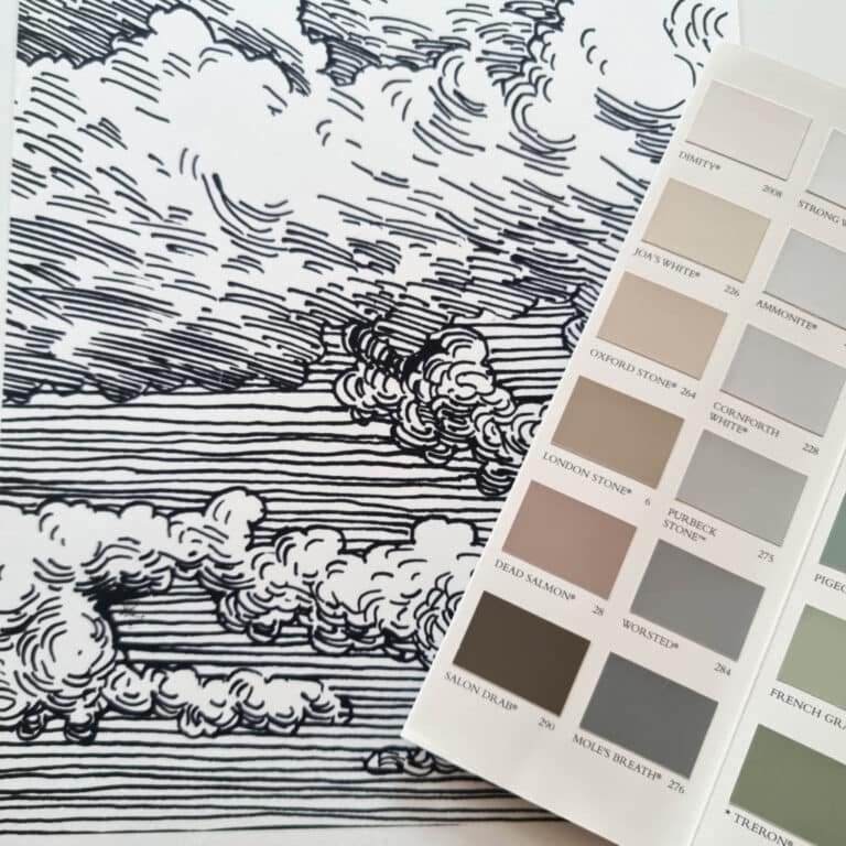 A paint colour swatch card with shades of grey and beige rests on a black and white line drawing of a cloudy sky and landscape—perfect inspiration for nursery décor for renters looking for easy, stylish rental nursery ideas.