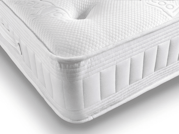 Close-up of the corner of a white mattress with a textured, quilted surface and reinforced side panels, showcasing clean stitching and modern design—an ideal choice among the best beds for summer.